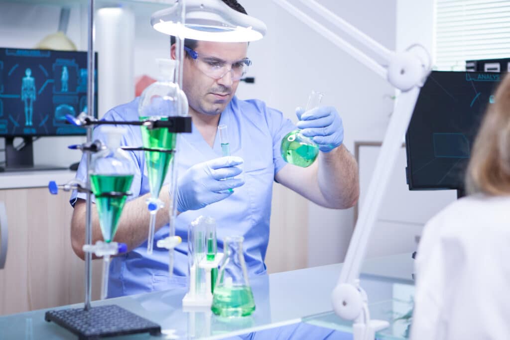 young scientist holding two test tubes research laboratory biologist working 1